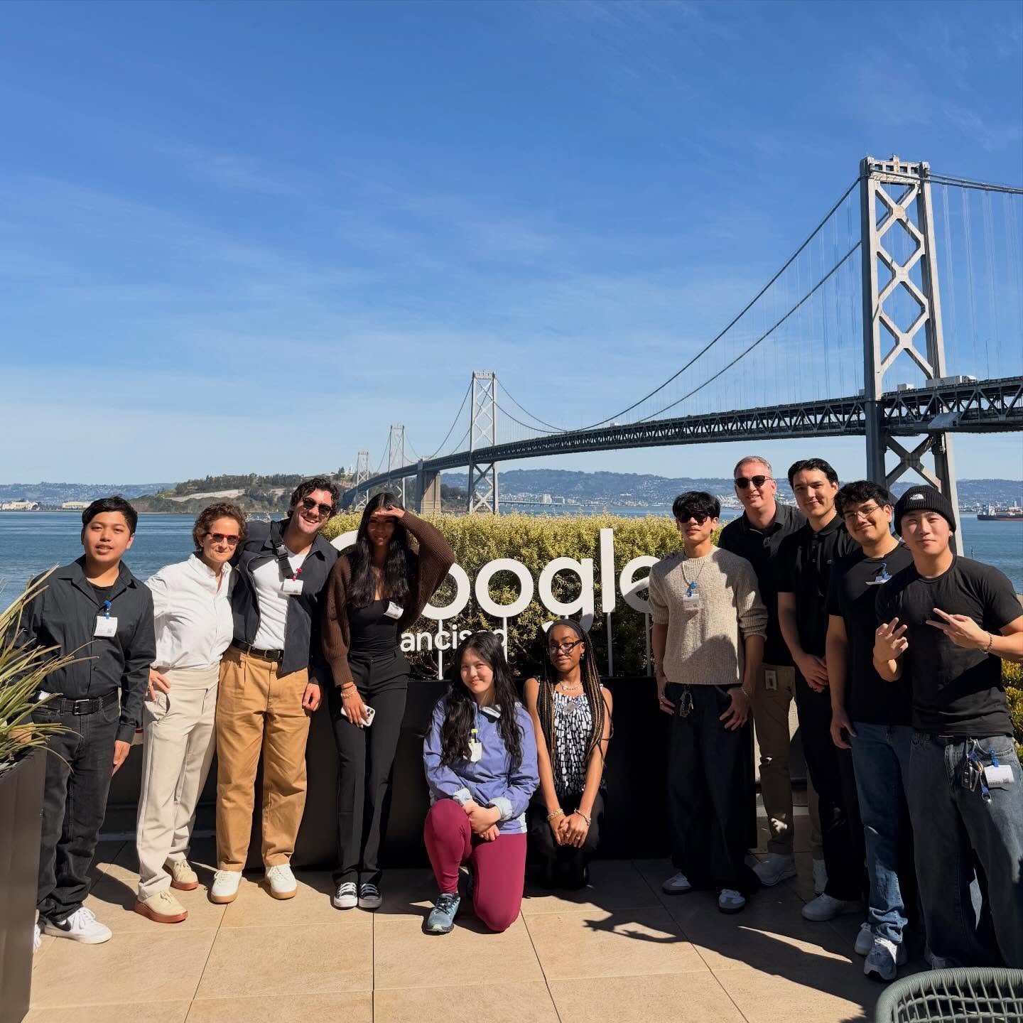 ABG officers in front of a Google sign with the Bay Bridge behind them
