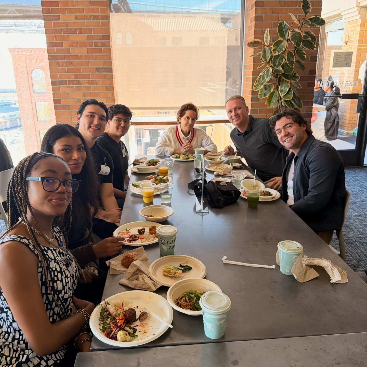 Officers and their hosts at lunch by the window