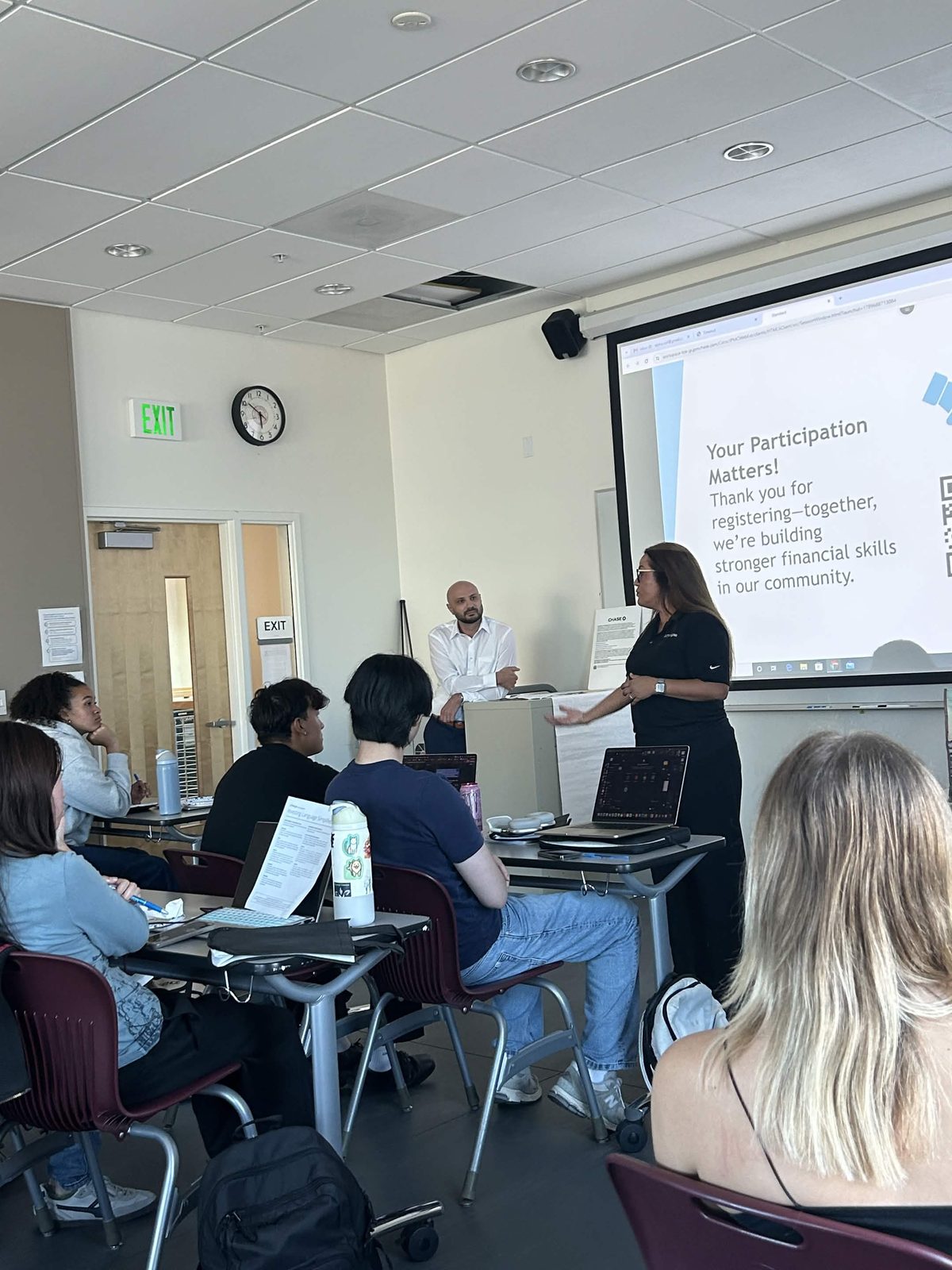 Jenny Baltodano of Chase speaks to members next to a slide reading “Your Participation Matters!”