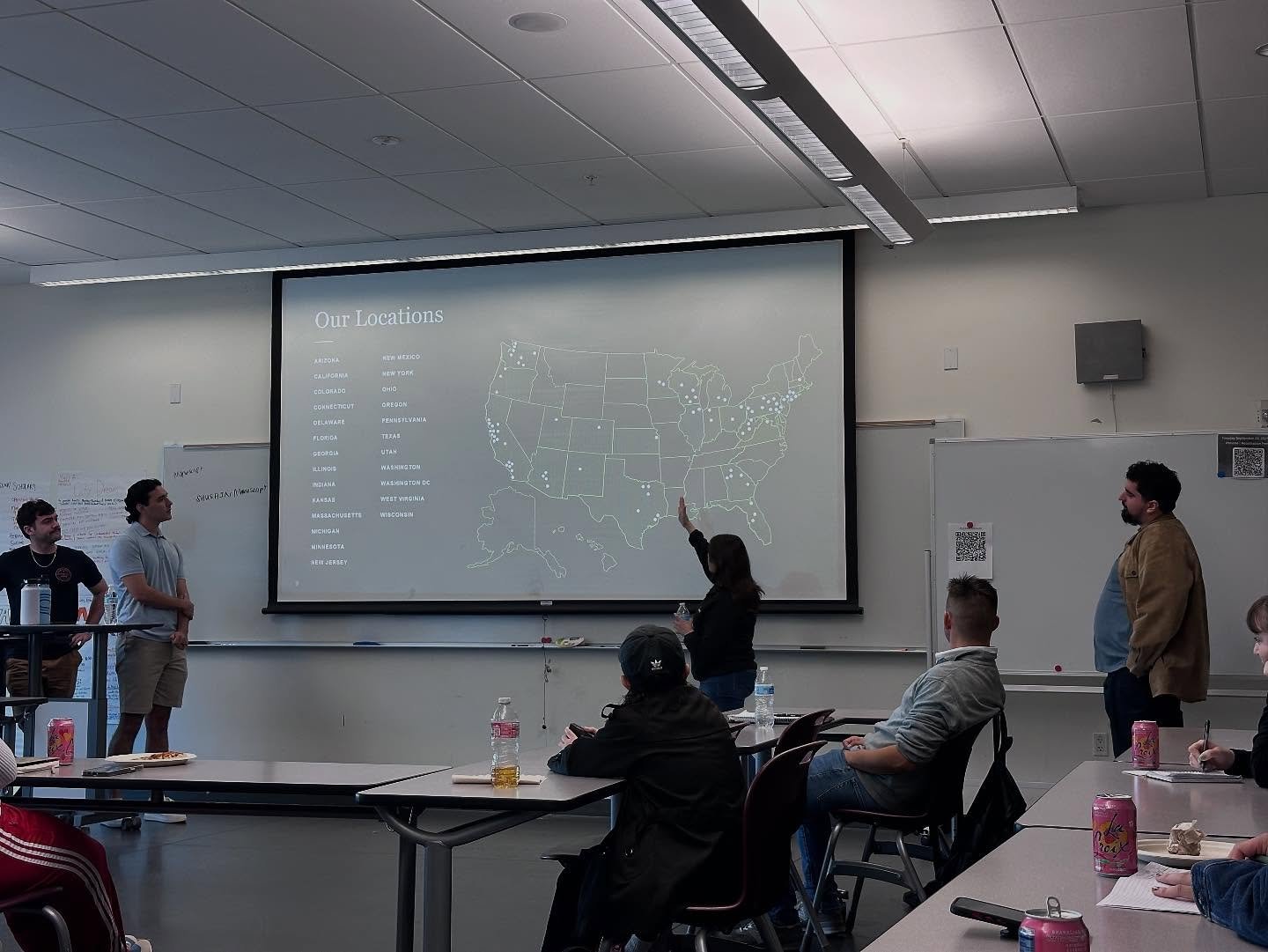 A presenter points to a map of the firm's U.S. locations