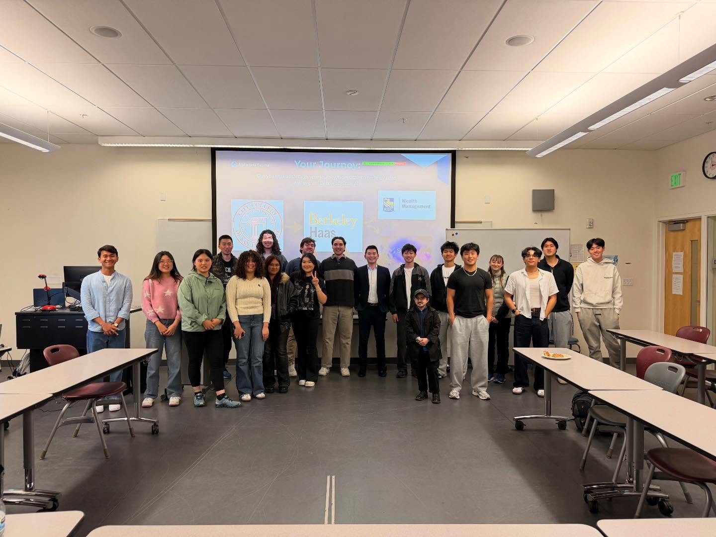 Group photo of ABG members with the speakers in front of the presentation screen